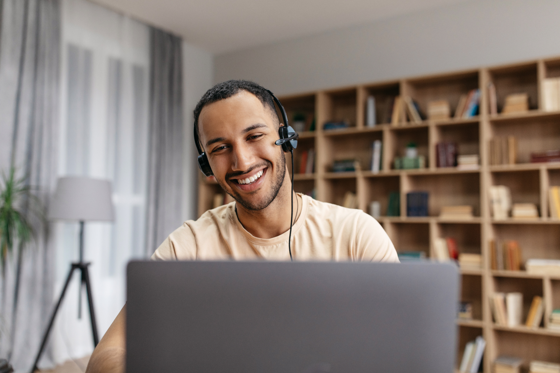 Student learning with laptop and headphones