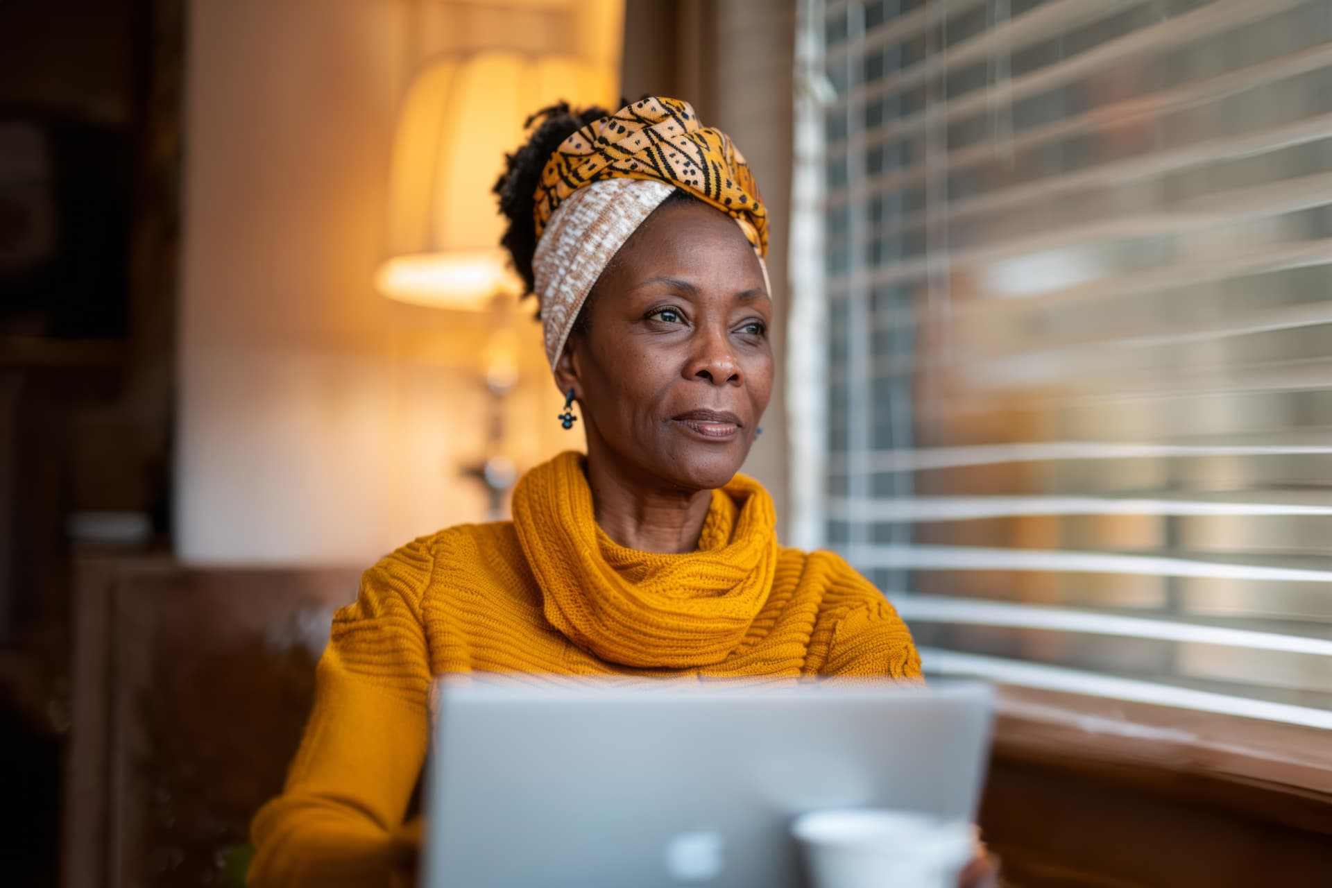 Learner focused on laptop with headphones